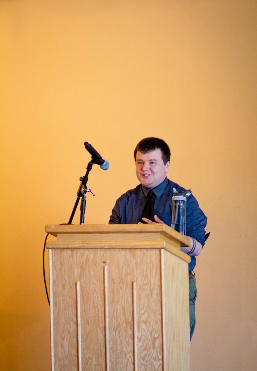 Photo of me at a podium.