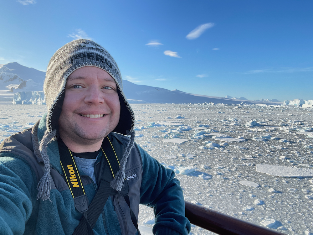Kyle in Antarctica with sea ice in the background